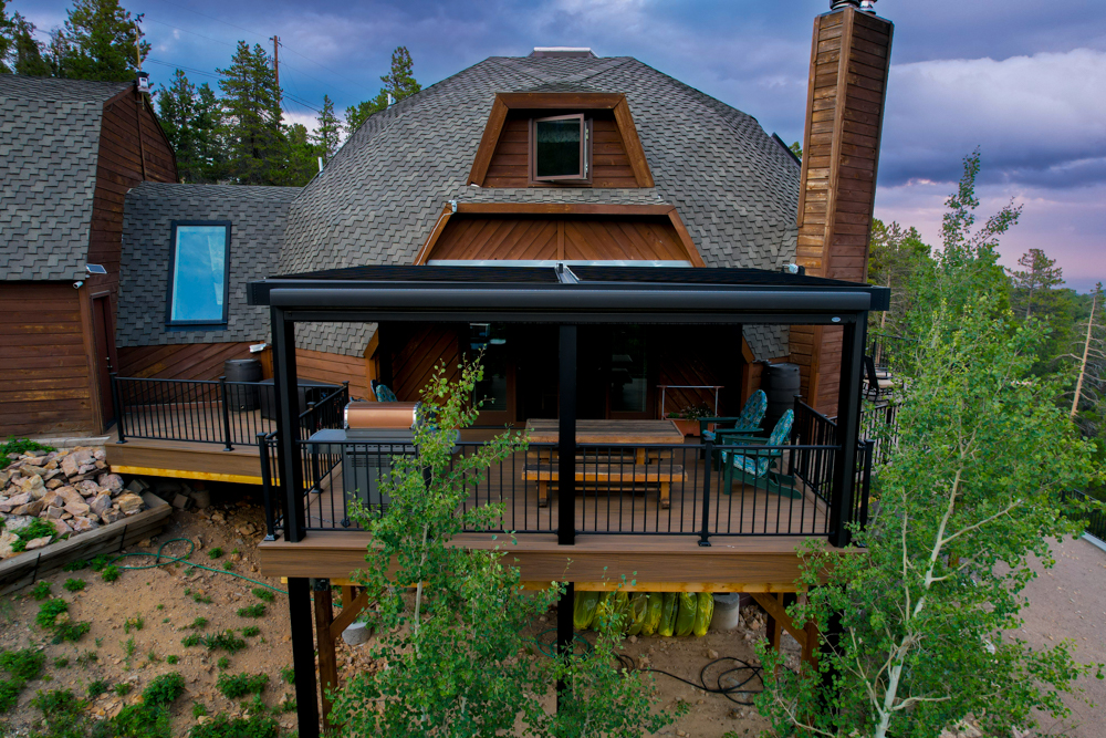 A deck with a motorized pergola