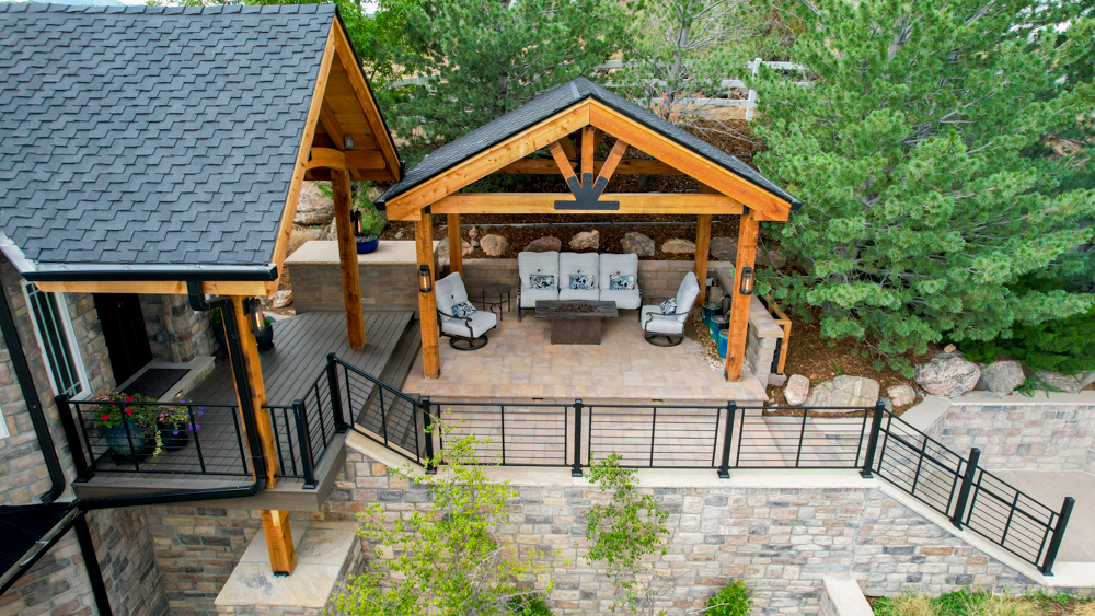 An ariel view of a grand entrance with a pergola and sitting area