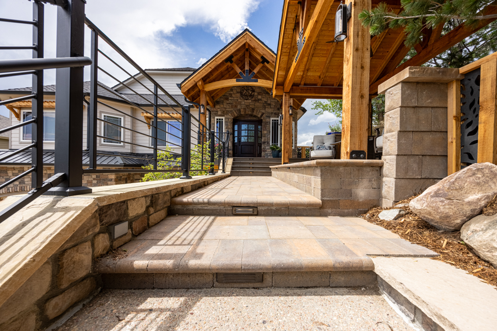 A hardscaped front entrance with accent lights