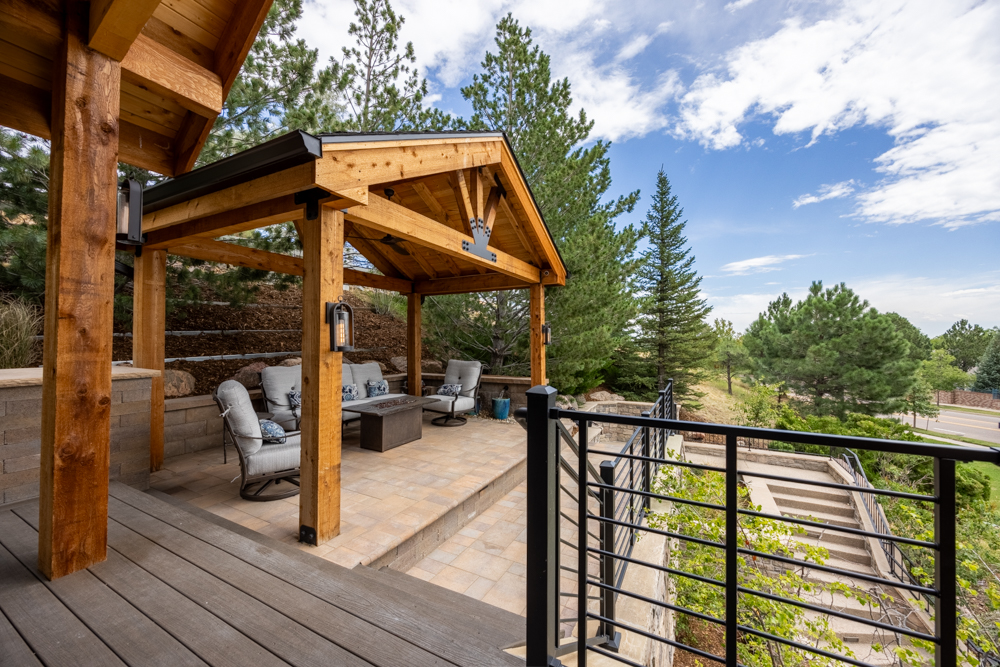 a grand entrance with a pergola and sitting area