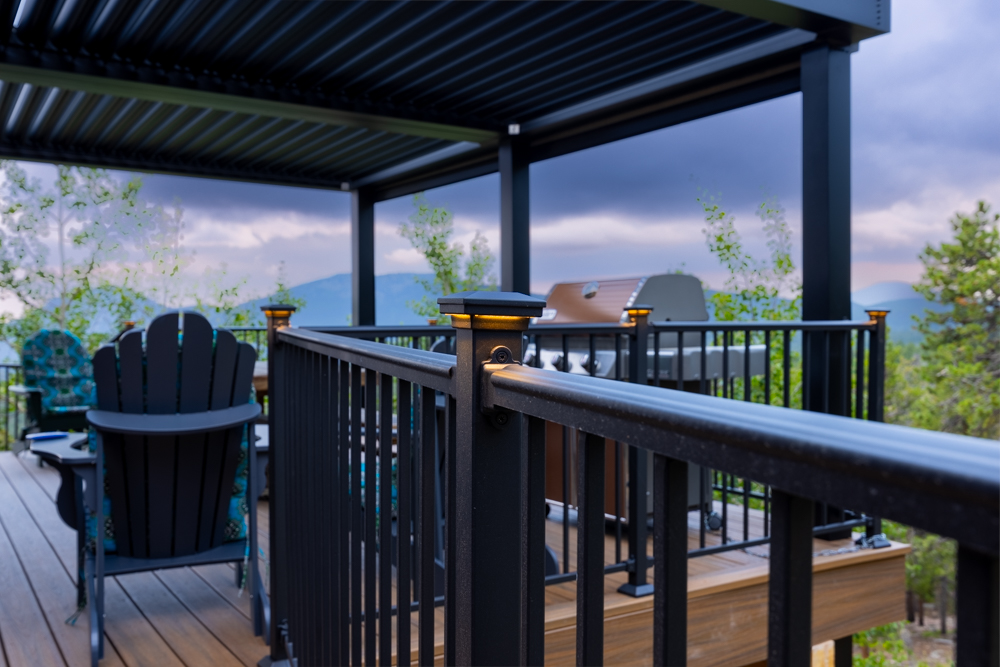 A wrap around deck with accent lights on the posts