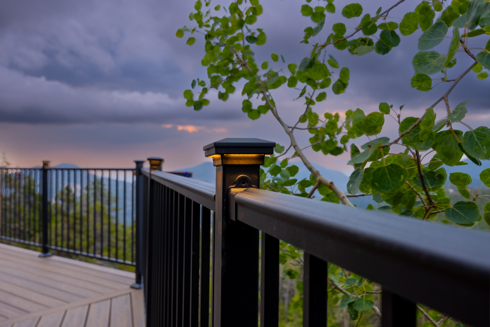 Soft accent lights on the railing of a deck