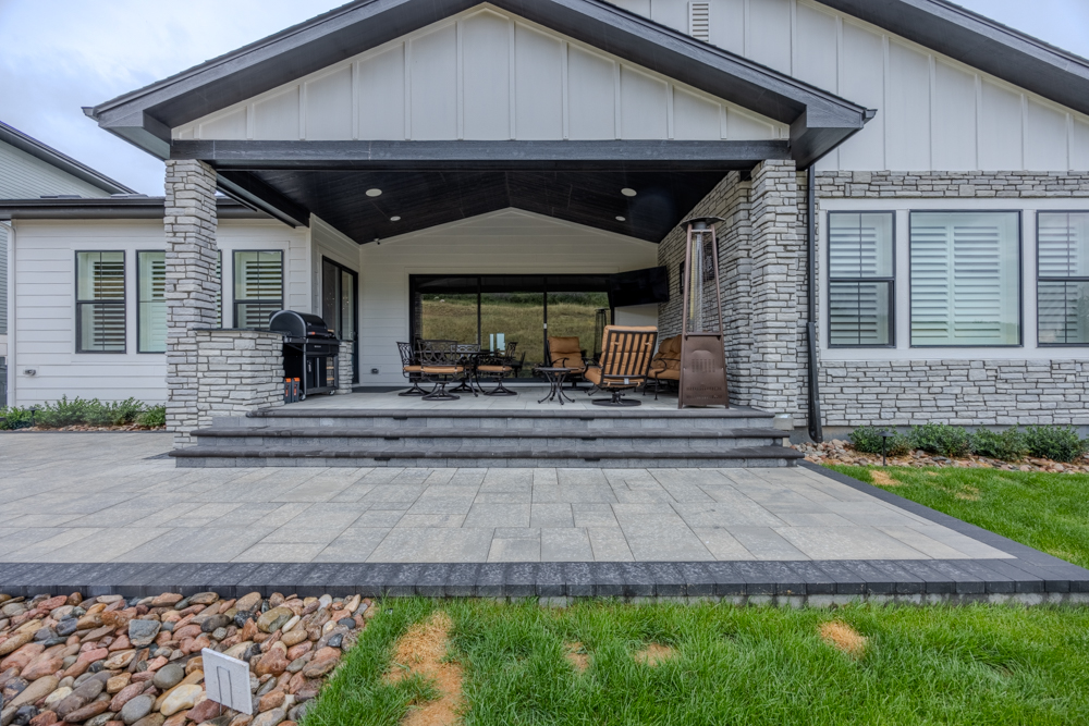 A deck with a pergola and hardscaping