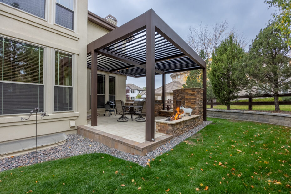 backyard patio and pergola with fire place and retaining wall