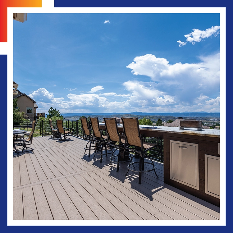 Composite deck with a built-in bar, outdoor kitchen, and mountain views